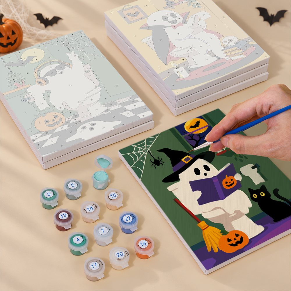 Painting one of the Boo Bathroom Buddies designs next to a stack of mini canvases