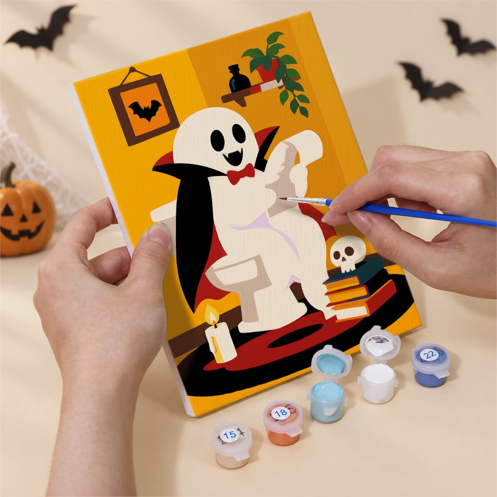 Hand holding a Boo Bathroom Buddies mini canvas while painting the details