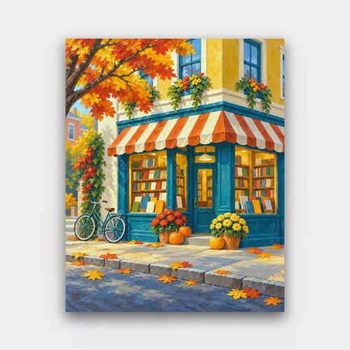 Bookshop on the Corner paint by numbers kit of a teal corner bookshop with a striped awning, pumpkins, mums and a bicycle in autumn