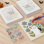 Painting one of the Botanical Black Cats designs next to a stack of mini canvases