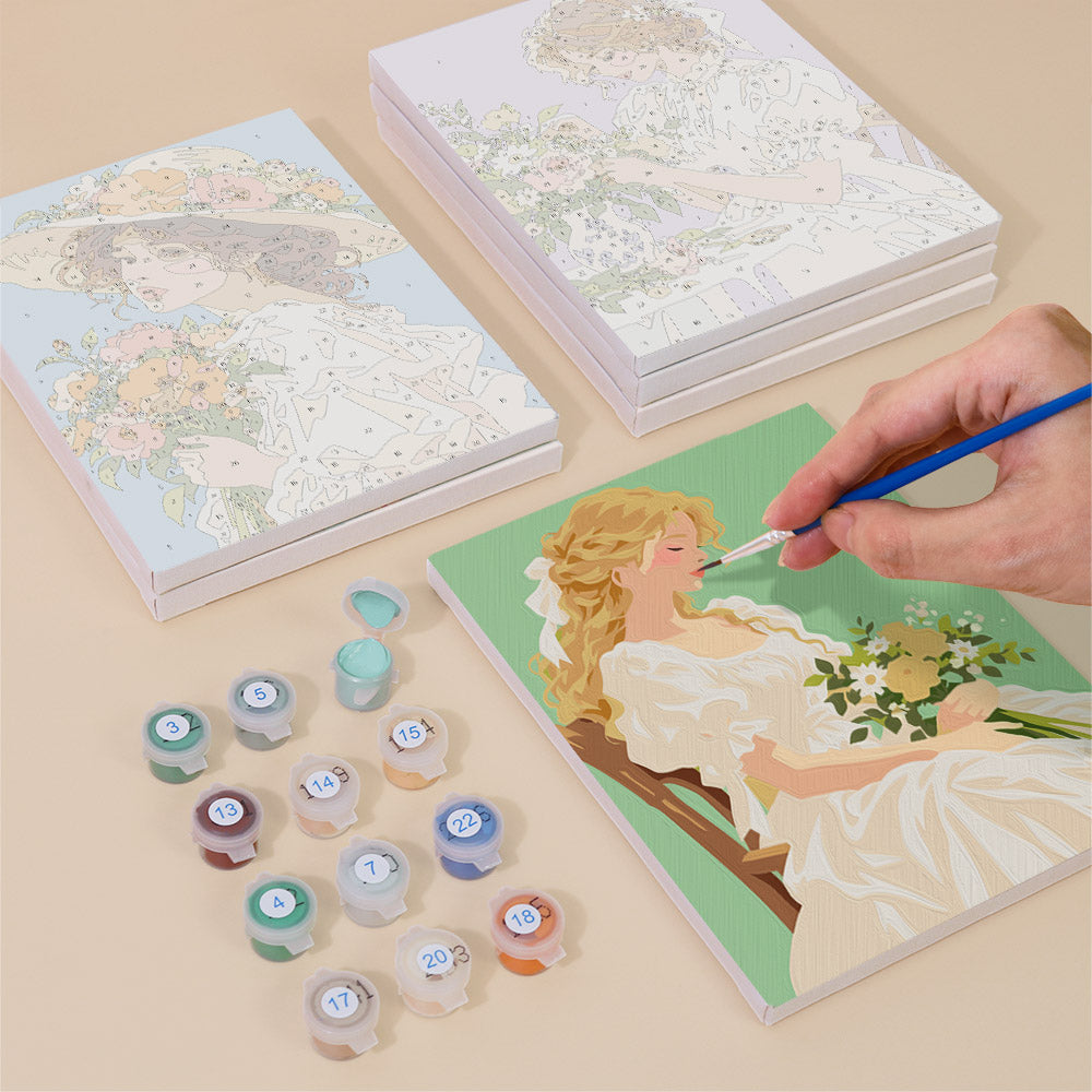 Painting one of the Bouquet Belles designs next to a stack of mini canvases