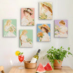 Six finished Bouquet Belles mini paintings hung on a wall above a table
