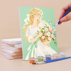 Painting a Bouquet Belles mini canvas propped up beside numbered acrylic paints