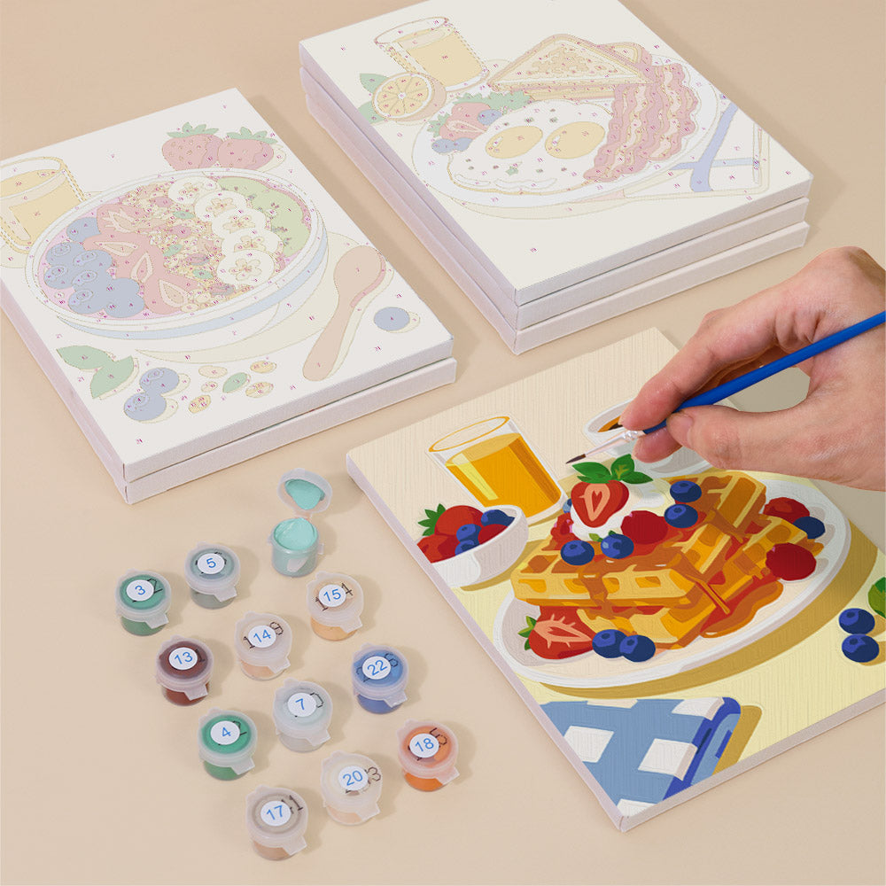 Painting one of the Breakfast Spread designs next to a stack of mini canvases