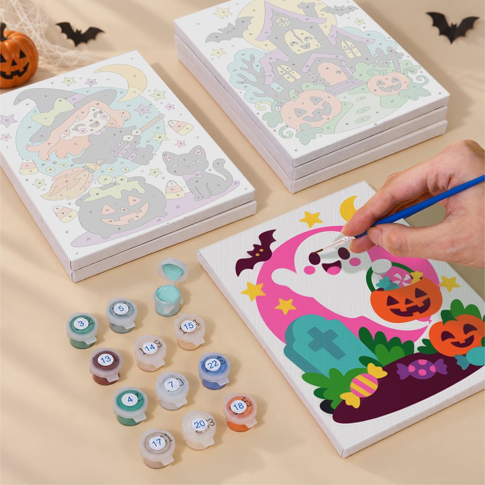 Painting one of the Bright Halloween Buddies designs next to a stack of mini canvases