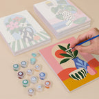 Painting one of the Bright Interiors designs next to a stack of mini canvases