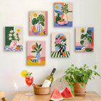 Six finished Bright Interiors mini paintings hung on a wall above a table