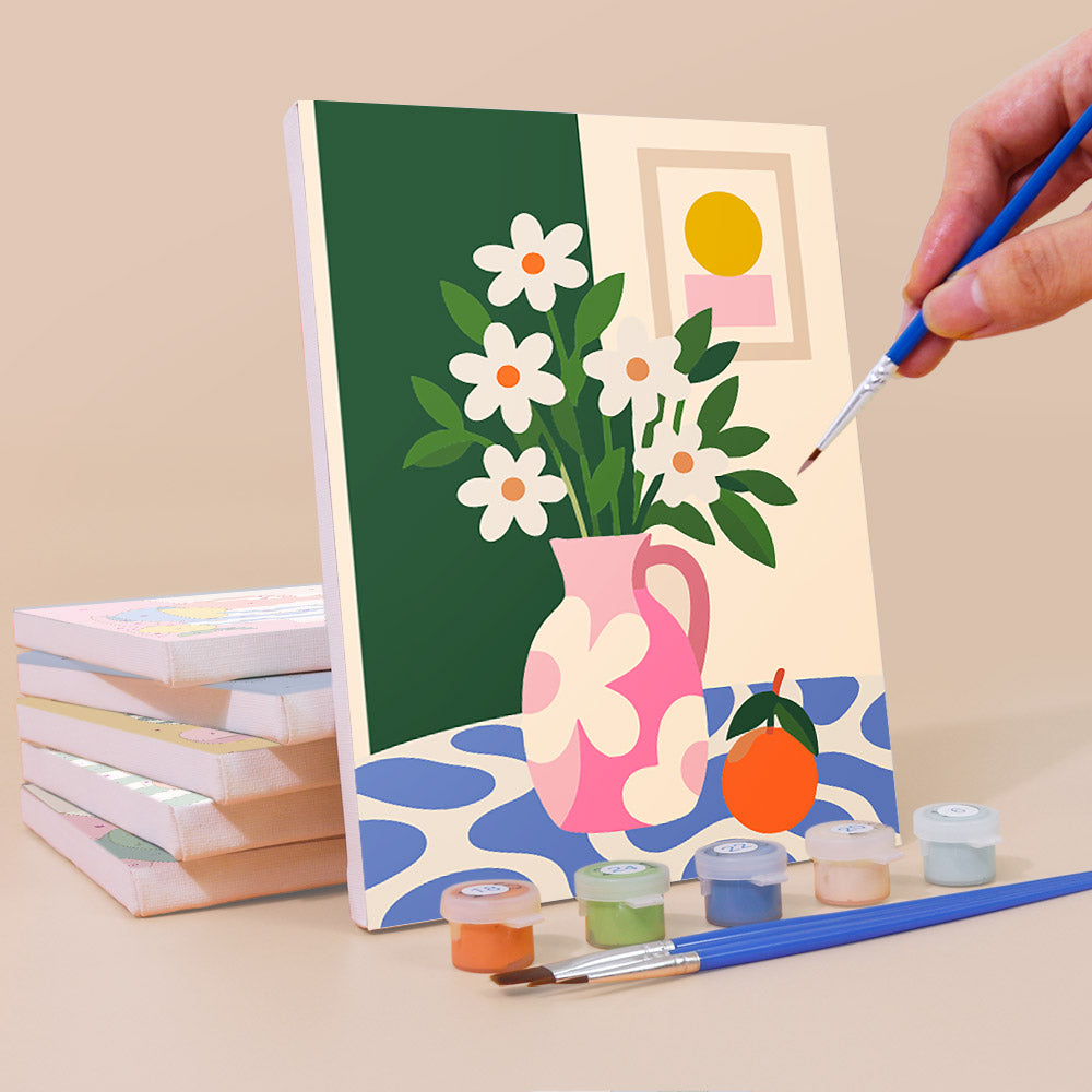 Painting a Bright Interiors mini canvas propped up beside numbered acrylic paints