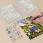 Painting one of the Bunny Garden designs next to a stack of mini canvases