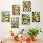 Six finished Bunny Garden mini paintings hung on a wall above a table