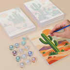 Painting one of the Cactus Country designs next to a stack of mini canvases