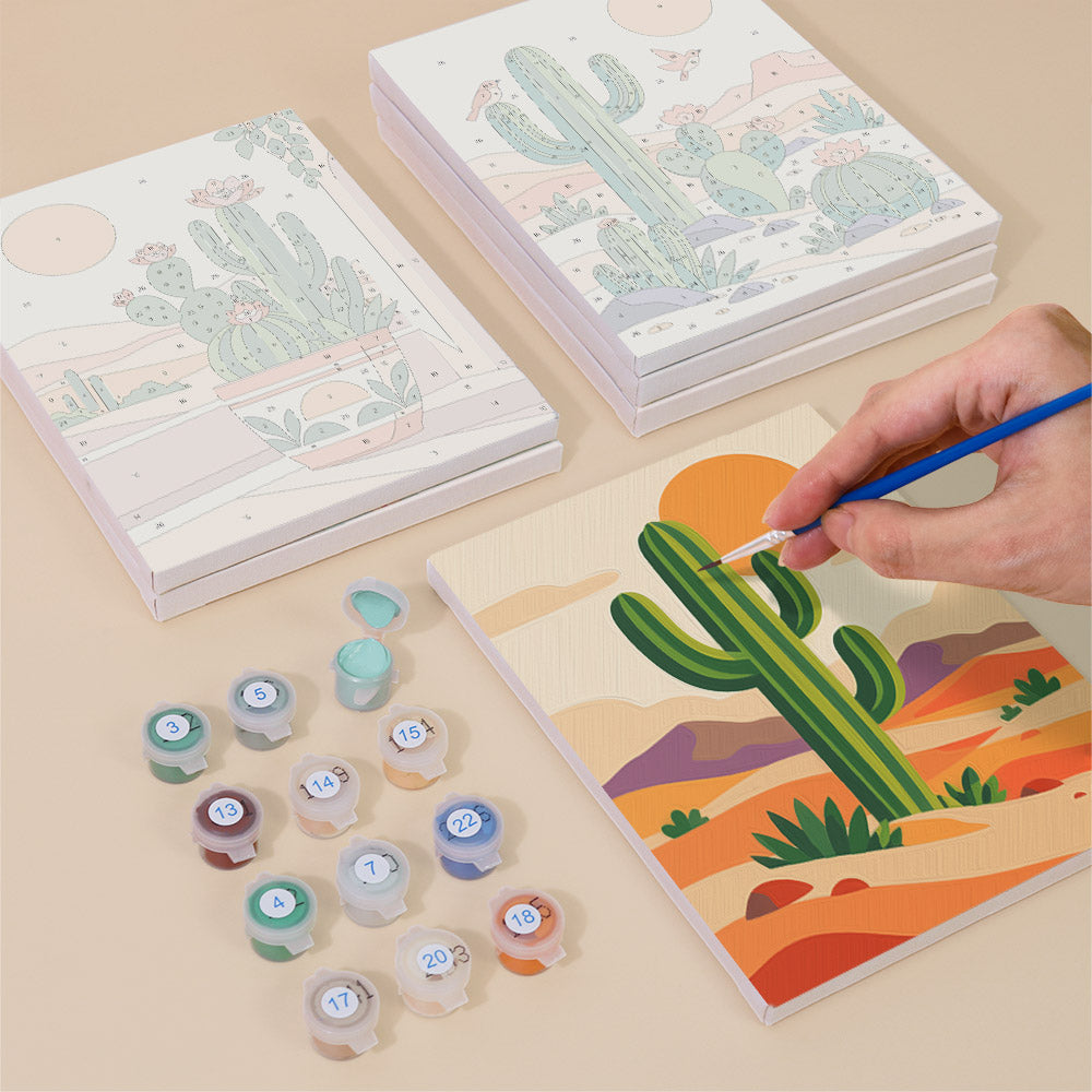 Painting one of the Cactus Country designs next to a stack of mini canvases