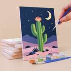 Painting a Cactus Country mini canvas propped up beside numbered acrylic paints