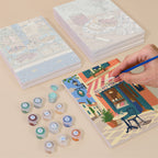 Painting one of the Café Mornings designs next to a stack of mini canvases