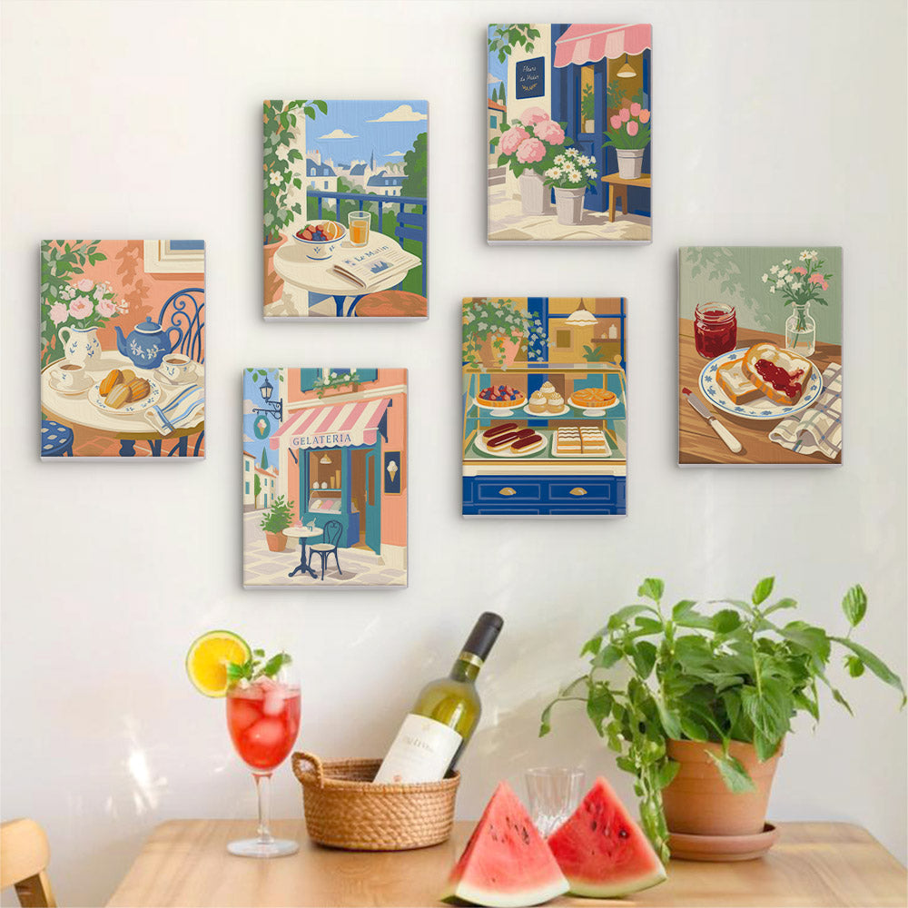 Six finished Café Mornings mini paintings hung on a wall above a table