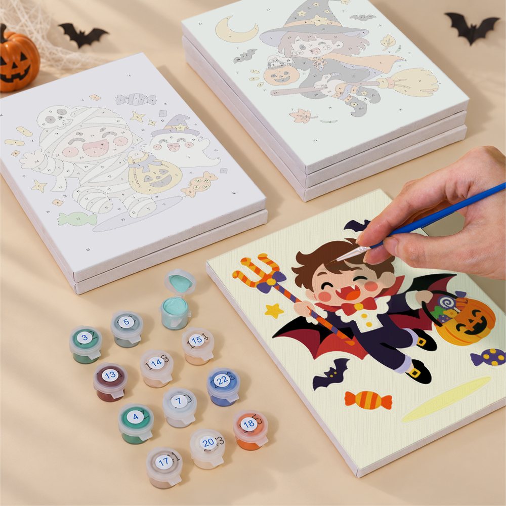 Painting one of the Candy Corn Chibis designs next to a stack of mini canvases