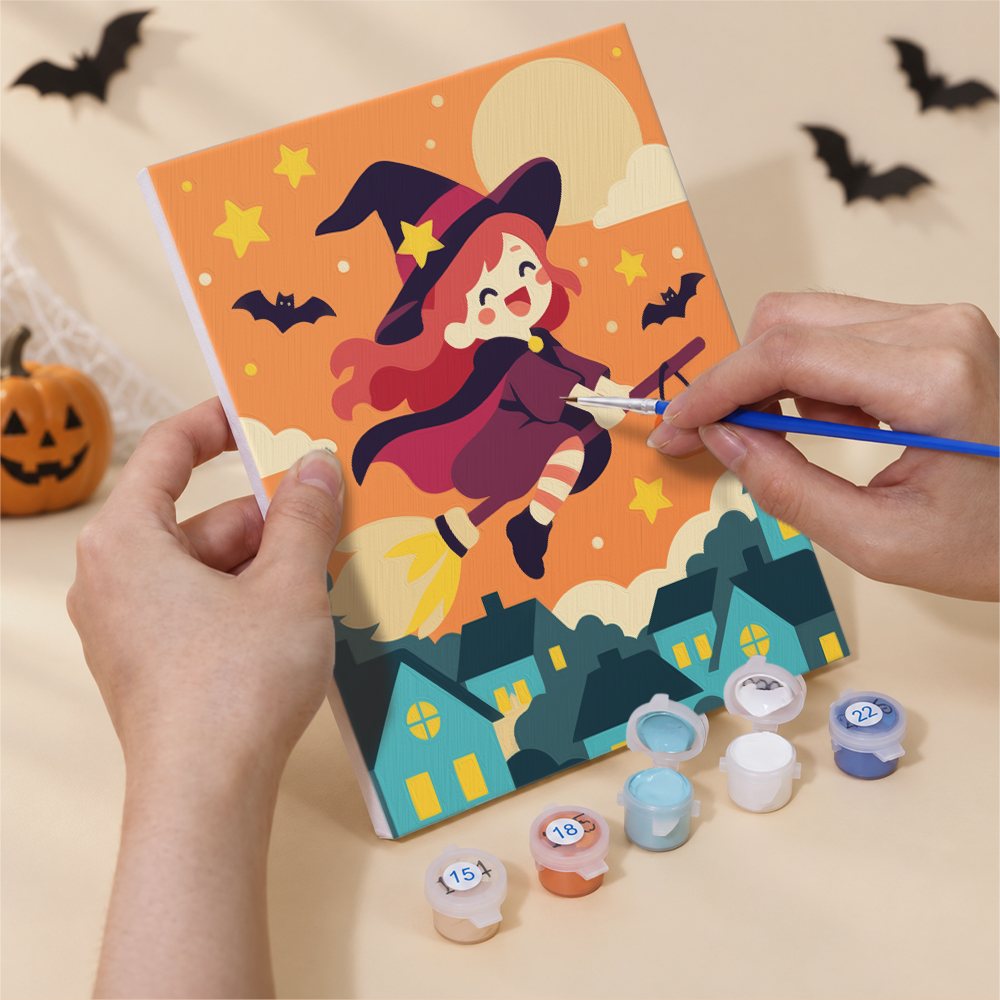 Hand holding a Candy Sky Halloween mini canvas while painting the details