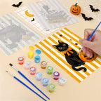 Filling in a Candy Stripe Spooks mini canvas with numbered acrylic paints and a fine brush