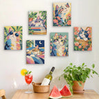 Six finished Cats in Bloom mini paintings hung on a wall above a table