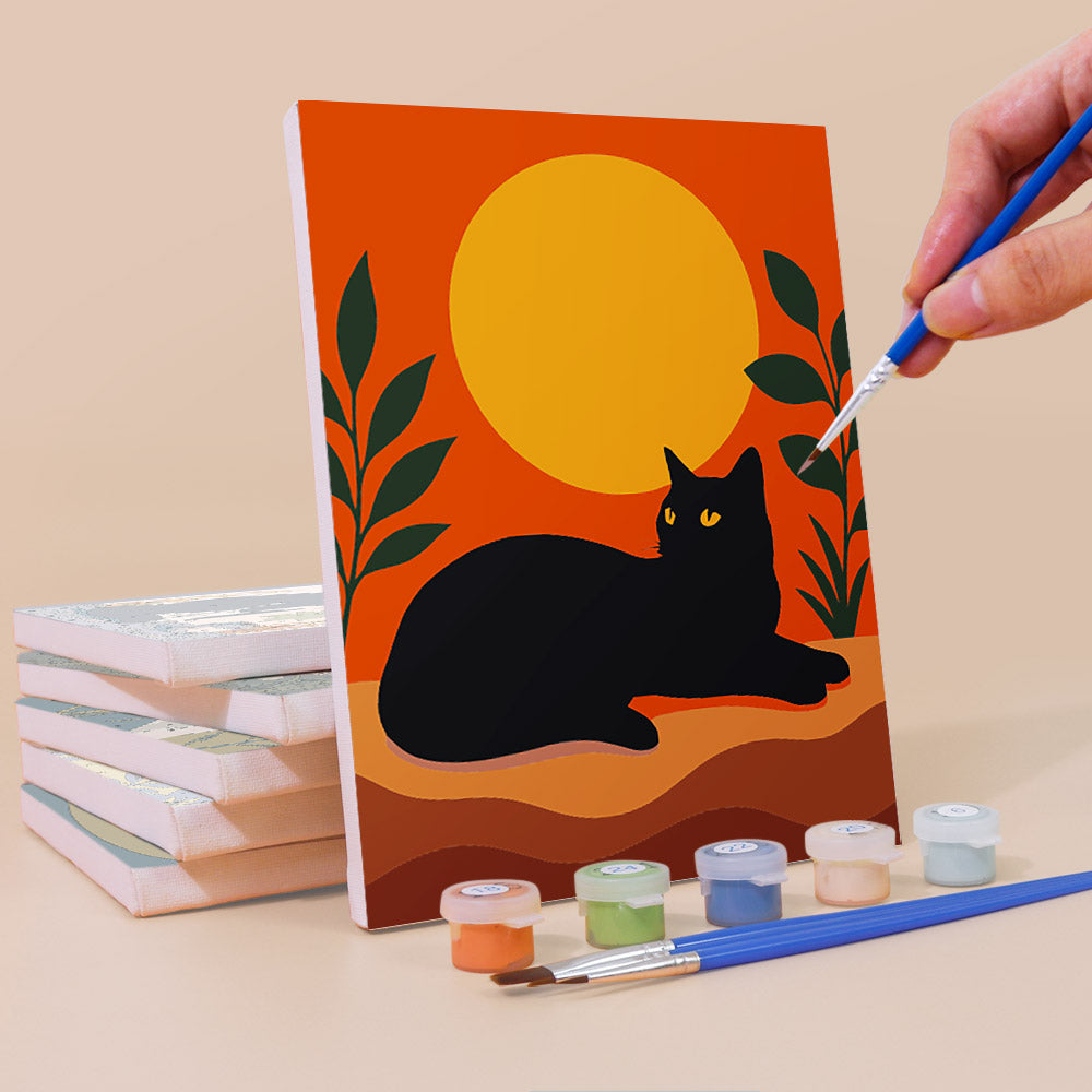 Painting a Cats Through the Seasons mini canvas propped up beside numbered acrylic paints
