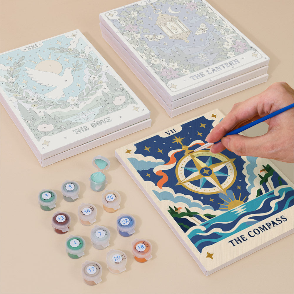 Painting one of the Celestial Cards designs next to a stack of mini canvases