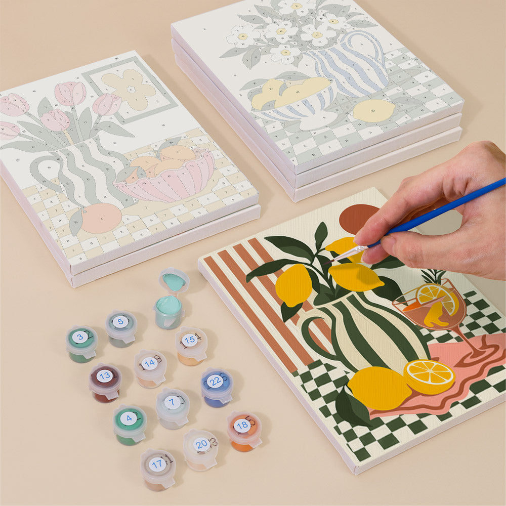 Painting one of the Checkerboard Still Life designs next to a stack of mini canvases