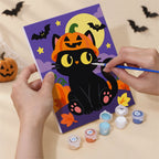 Hand holding a Checkered Cat Pumpkins mini canvas while painting the details