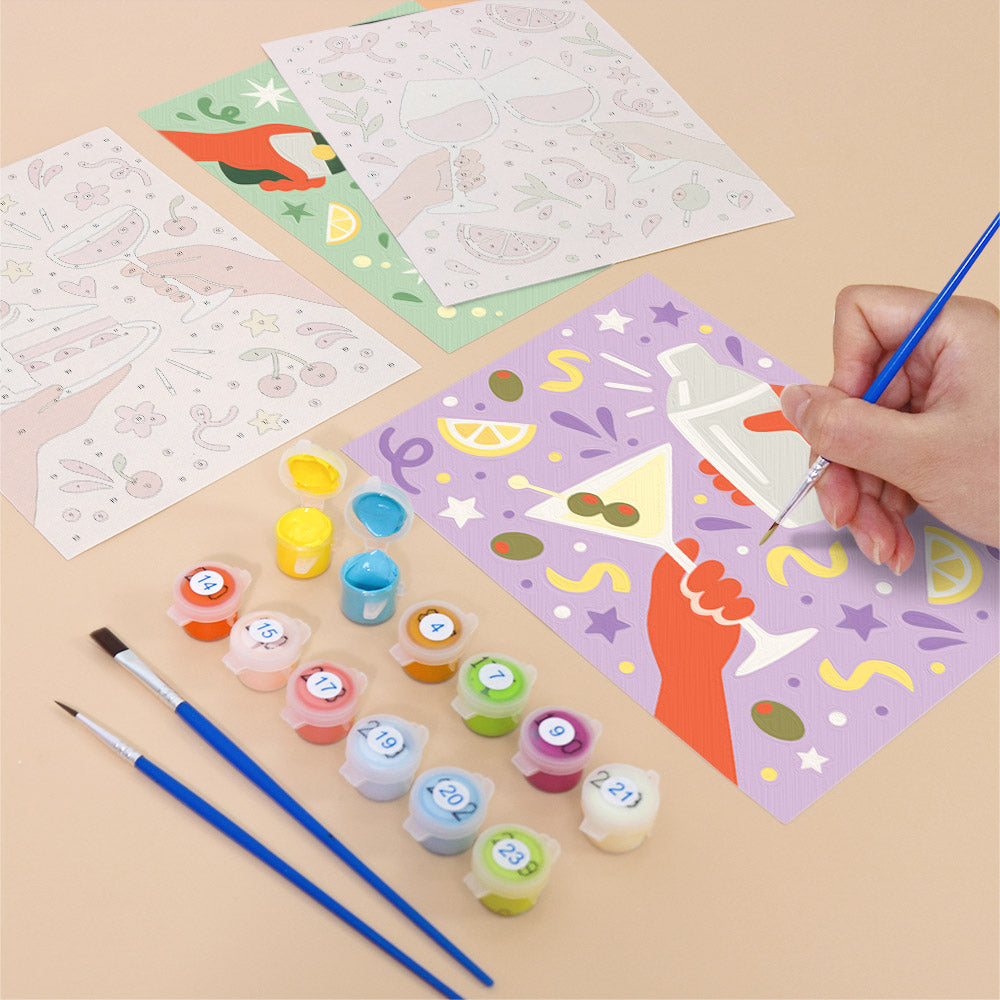 Filling in a Cheers and Treats mini canvas with numbered acrylic paints and a fine brush