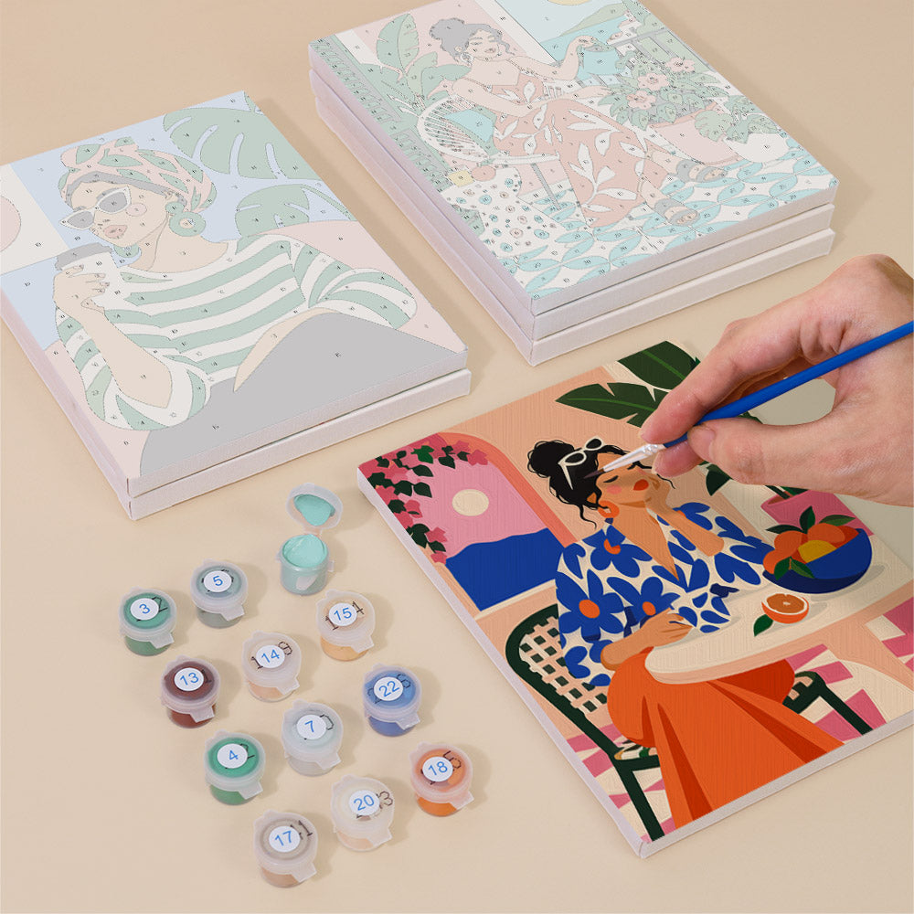 Painting one of the Chic at Home designs next to a stack of mini canvases