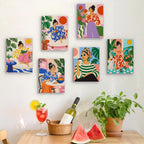 Six finished Chic at Home mini paintings hung on a wall above a table