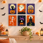 Classic Halloween mini paintings displayed as a gallery wall in a sunny kitchen