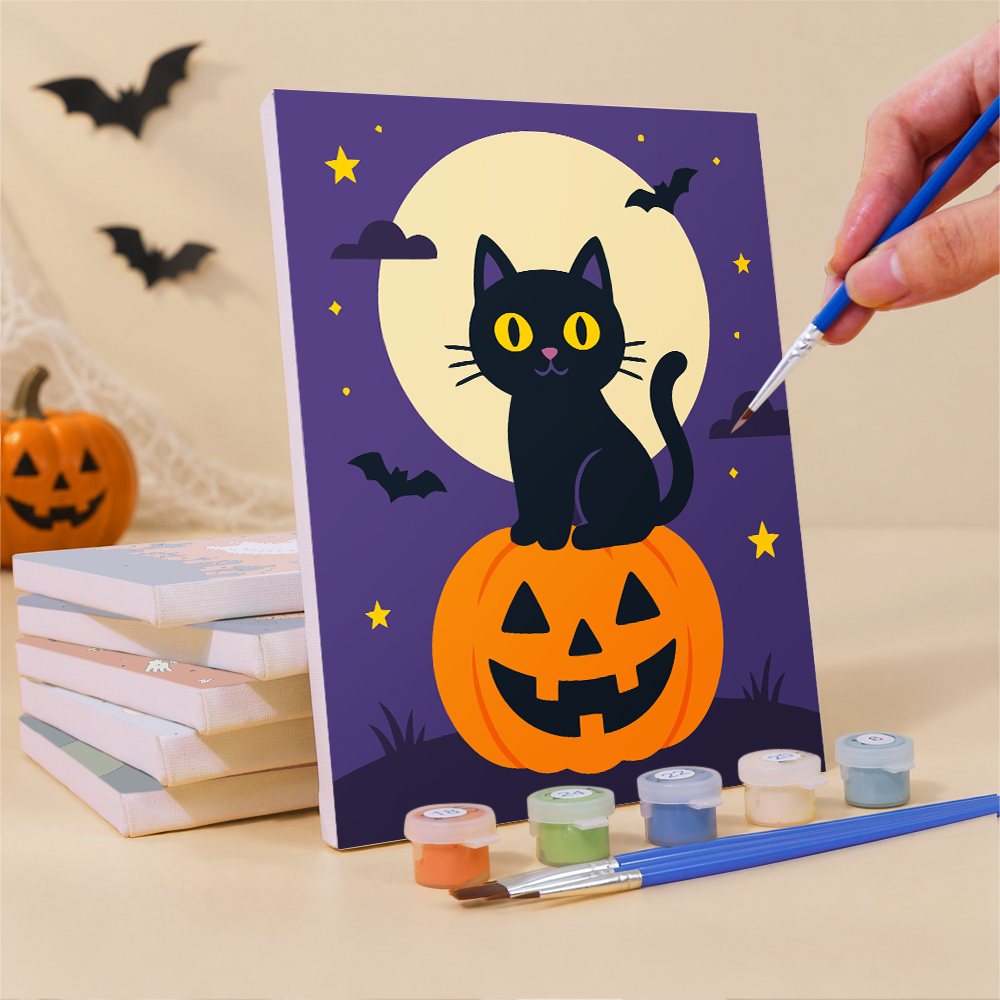 Painting a Classic Halloween mini canvas propped up beside numbered acrylic paints