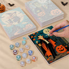 Painting one of the Classic Monster Moon designs next to a stack of mini canvases
