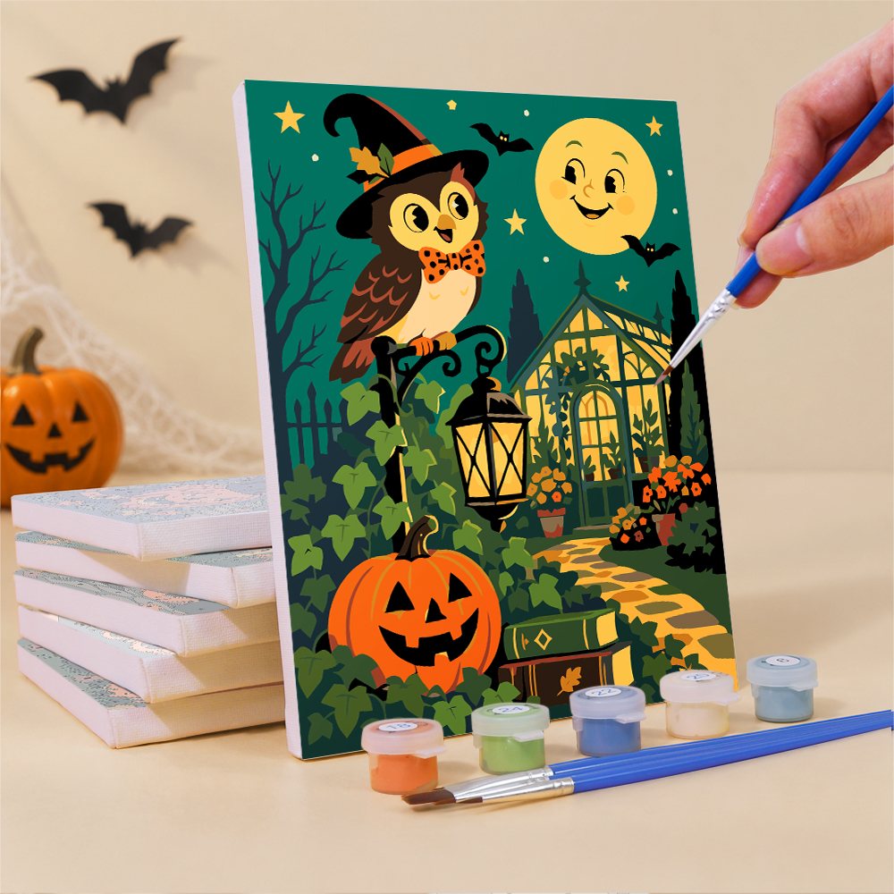 Painting a Classic Monster Moon mini canvas propped up beside numbered acrylic paints