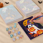 Painting one of the Classic Spooky Nights designs next to a stack of mini canvases