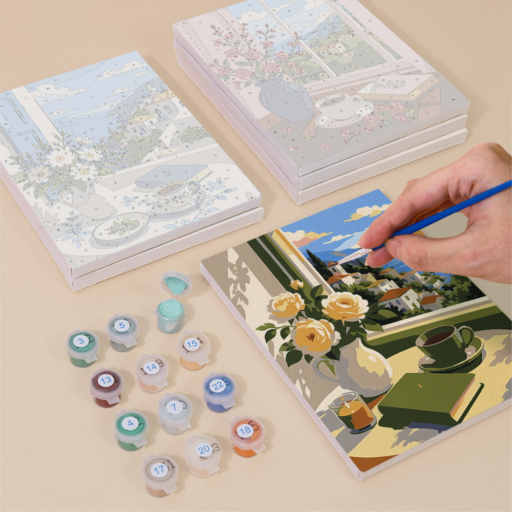 Painting one of the Coastal Breakfast designs next to a stack of mini canvases
