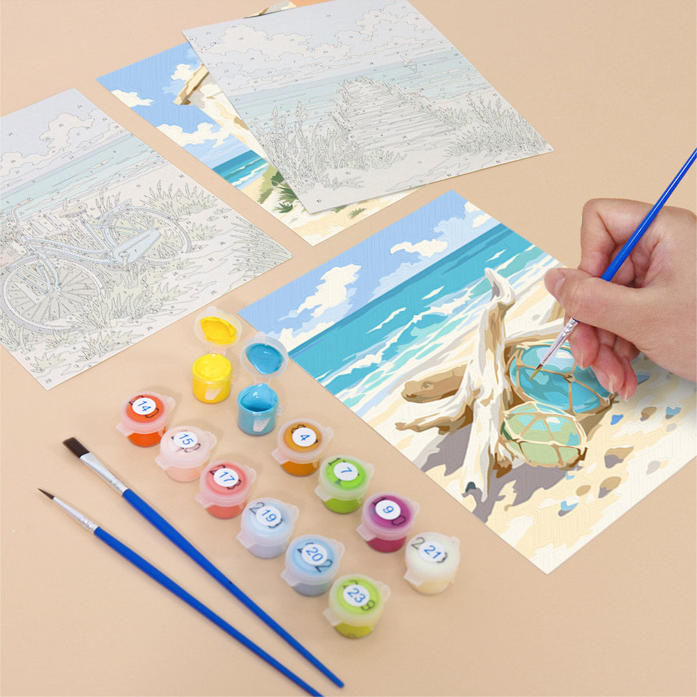 Filling in a Coastal Whites mini canvas with numbered acrylic paints and a fine brush