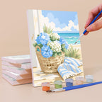 Painting a Coastal Whites mini canvas propped up beside numbered acrylic paints