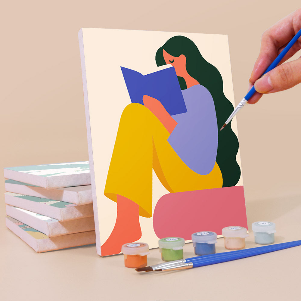 Painting a Color Block Ladies mini canvas propped up beside numbered acrylic paints