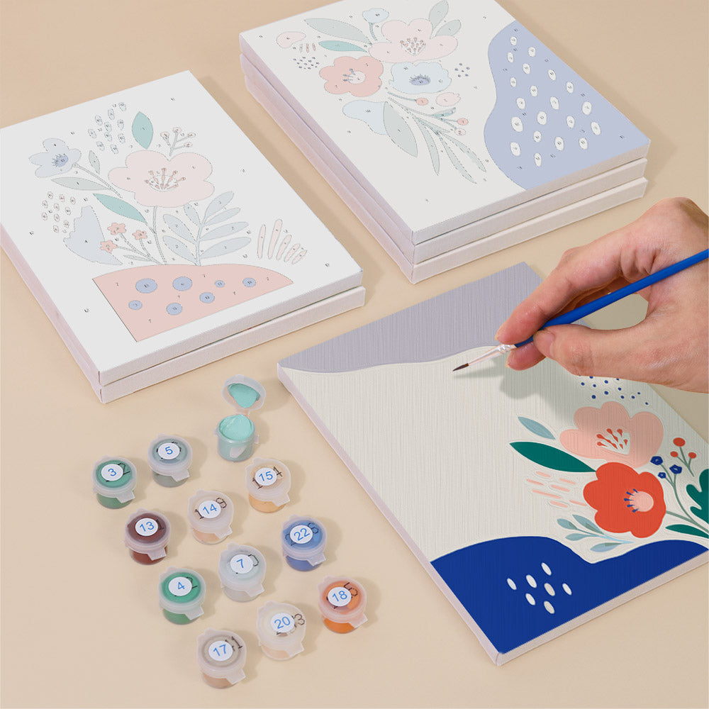 Painting one of the Confetti Petals designs next to a stack of mini canvases
