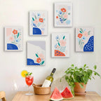 Six finished Confetti Petals mini paintings hung on a wall above a table