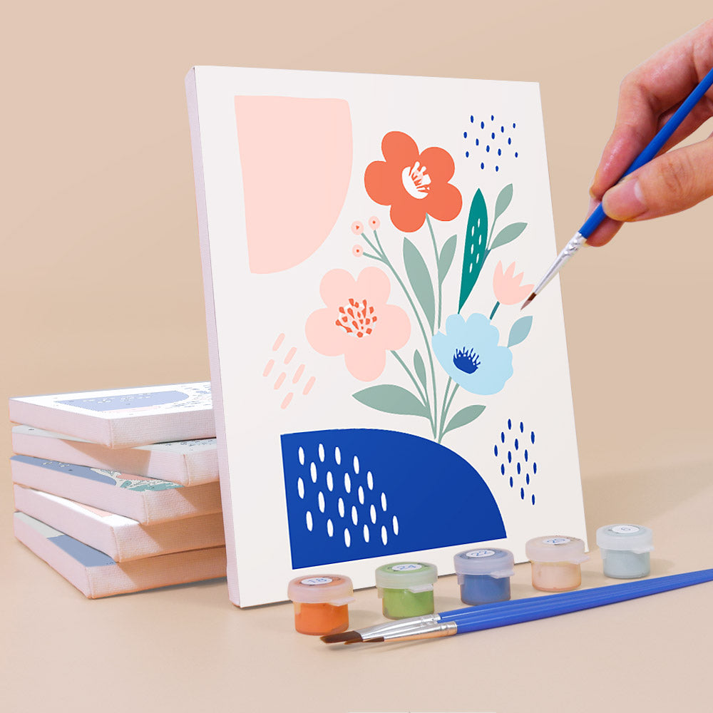 Painting a Confetti Petals mini canvas propped up beside numbered acrylic paints