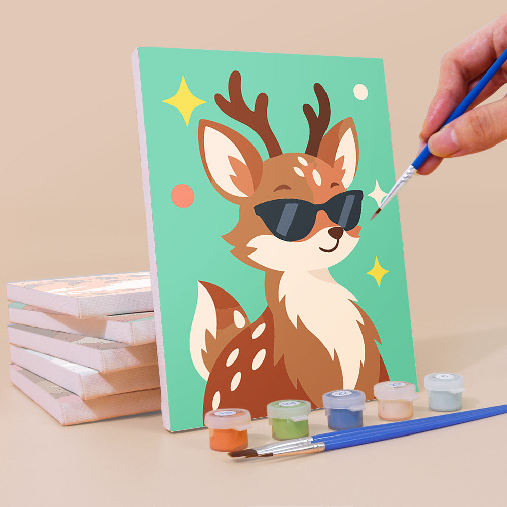 Painting a Cool Critters mini canvas propped up beside numbered acrylic paints