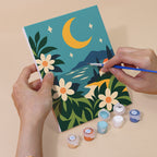 Hand holding a Cool Summer Vibes mini canvas while painting the details