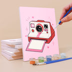 Painting the pink instant camera canvas from the Coquette Keepsakes mini paint by numbers set