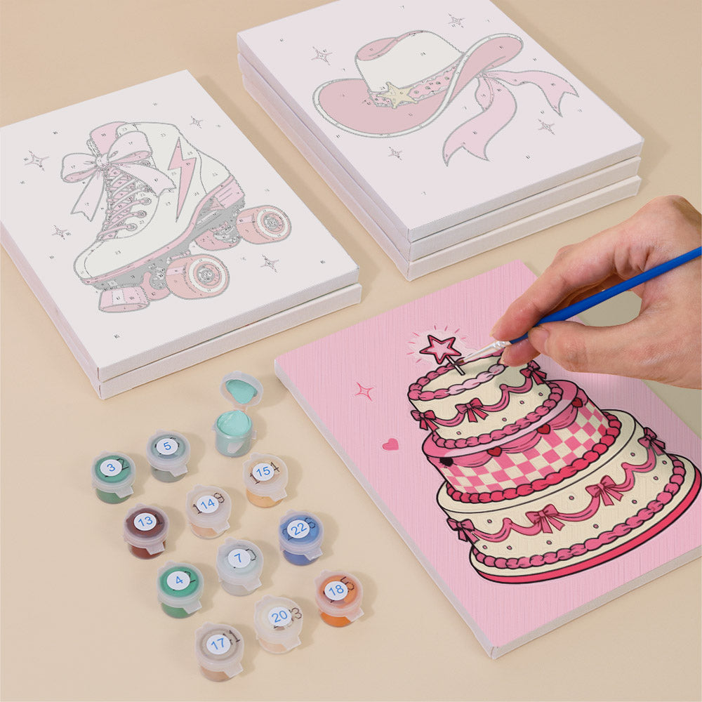 Painting the layered pink cake mini canvas with numbered acrylic paints