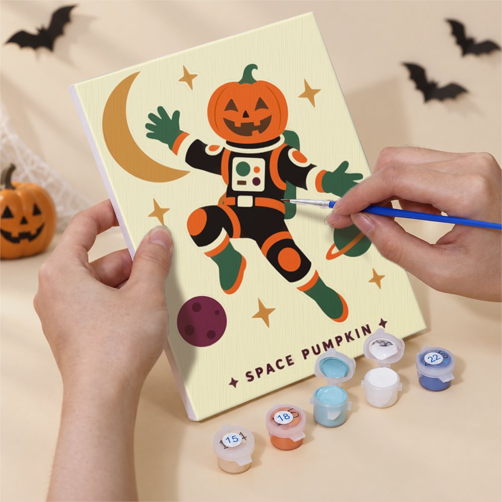 Hand holding a Cosmic Costume Characters mini canvas while painting the details
