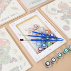 Numbered paint pots and brushes on a pre-stretched Cosmic Costume Characters mini canvas