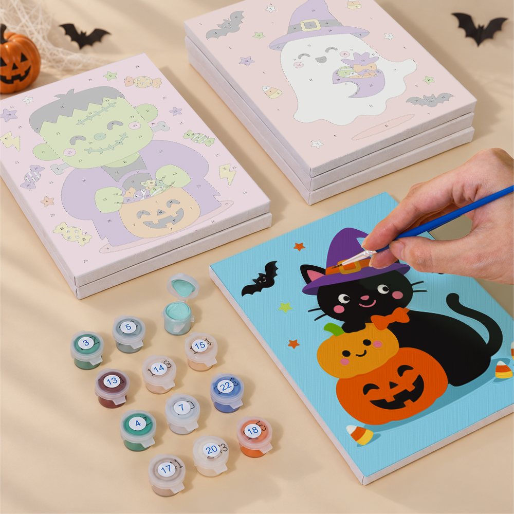 Painting one of the Costume Cuties designs next to a stack of mini canvases