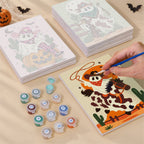 Painting one of the Cowboy Ghost Ranch designs next to a stack of mini canvases